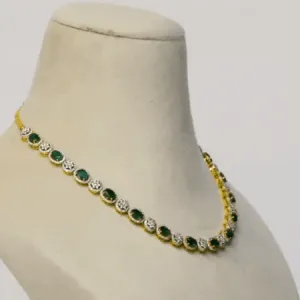 Enchant with elegance in our Emerald oval and diamond necklace and earring pair. Each piece exudes timeless sophistication and luxury.(GDNE0470)